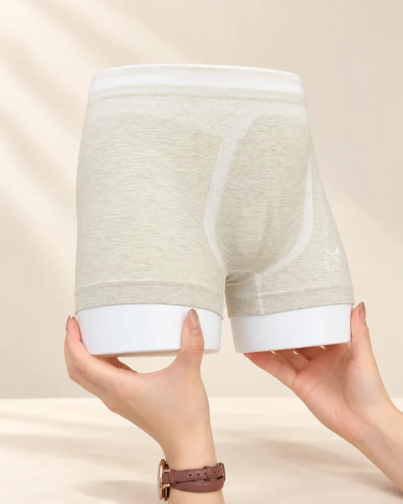 Sage kids seamless underwear on a display form held in two hands